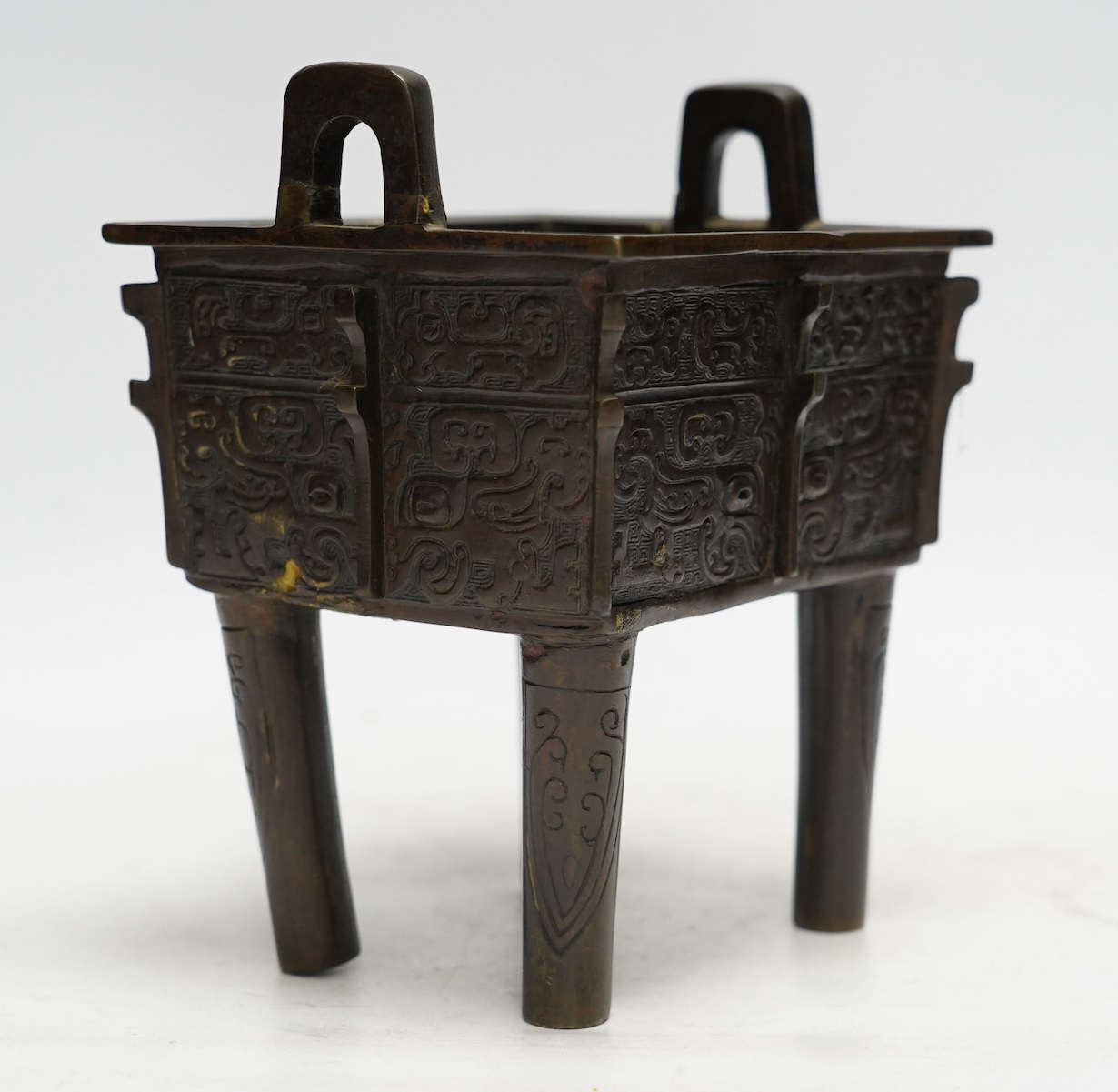 A Chinese archaistic bronze censer, fangding, Ming dynasty, repairs, 20cm